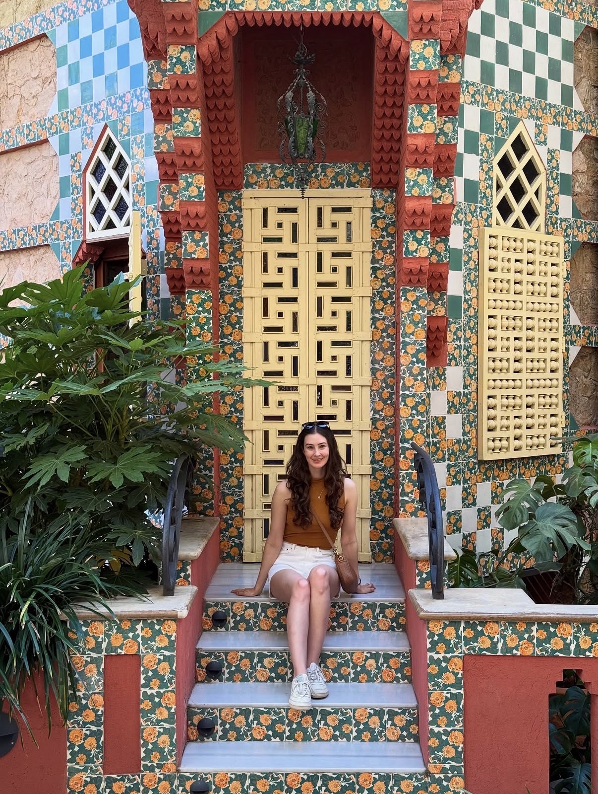 Tassia sitting on the tiled steps of Casa Vicens in Barcelona